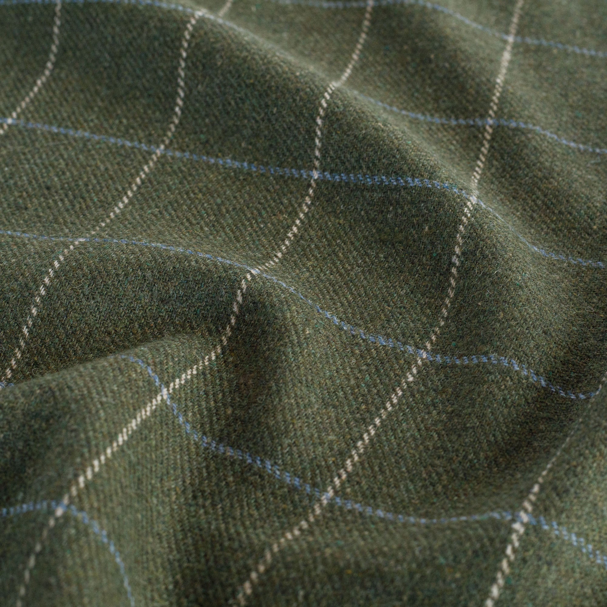 a moss green, beige and light blue multi use home decor fabric : close up view