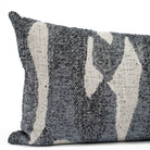 a denim blue and earthy grey organic abstract patterned lumbar pillow : close up view