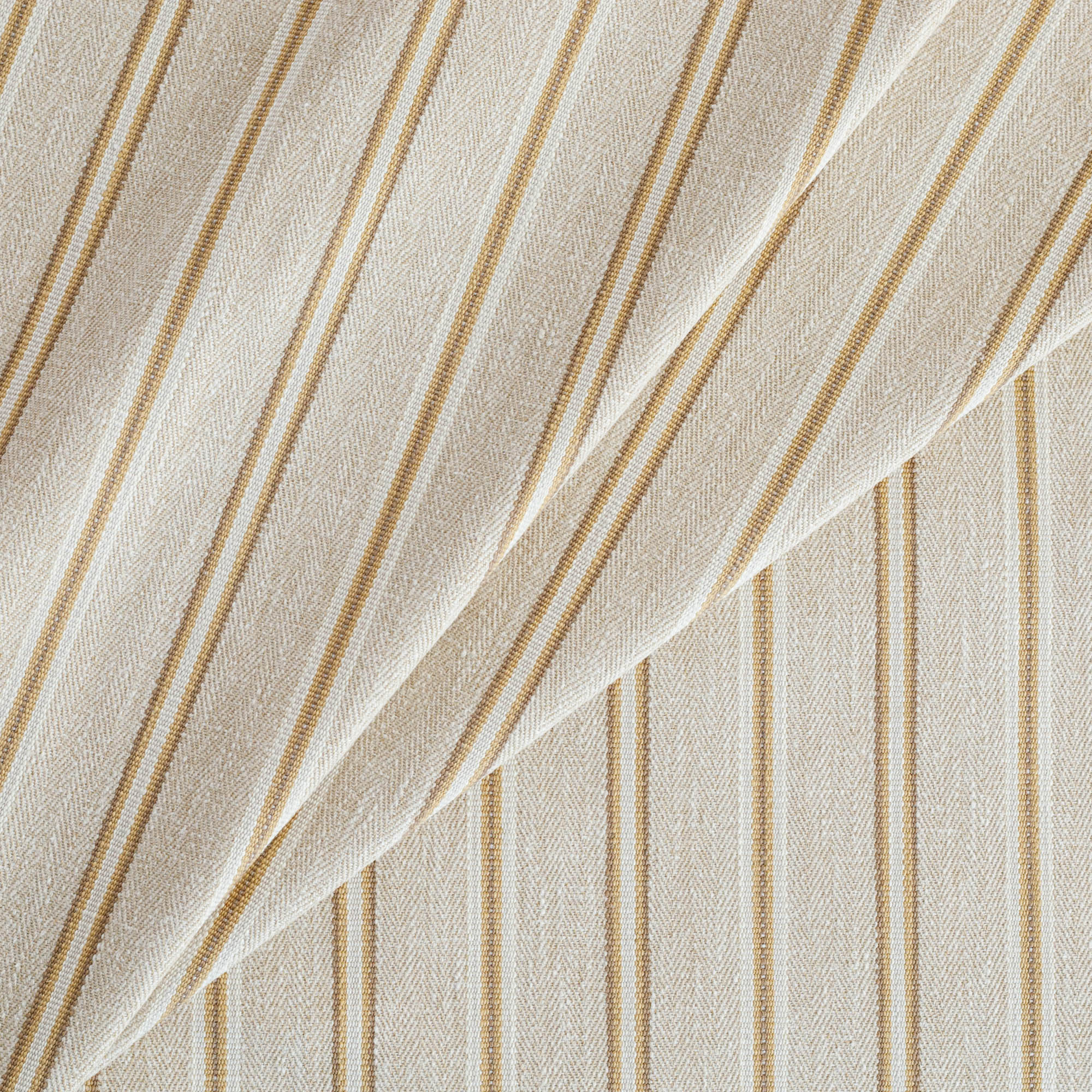 a beige, cream, ochre yellow and tan brown striped upholstery fabric from Tonic Living