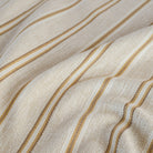 a beige, cream, ochre yellow and tan brown striped home decor fabric : close up view