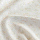 a tonal cream subtle block-print style floral print fabric : close up view