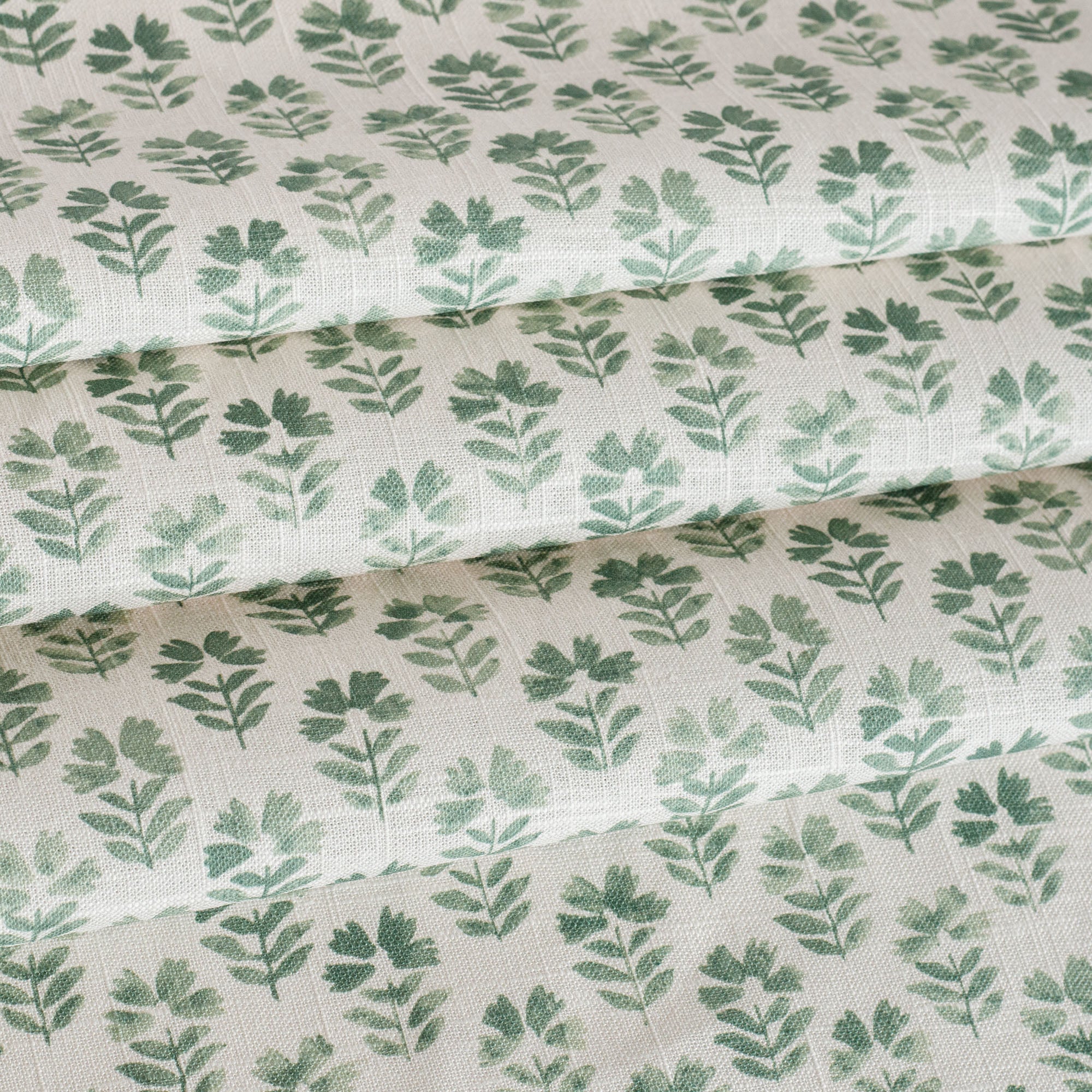 A white and green block print floral fabric from Tonic Living.