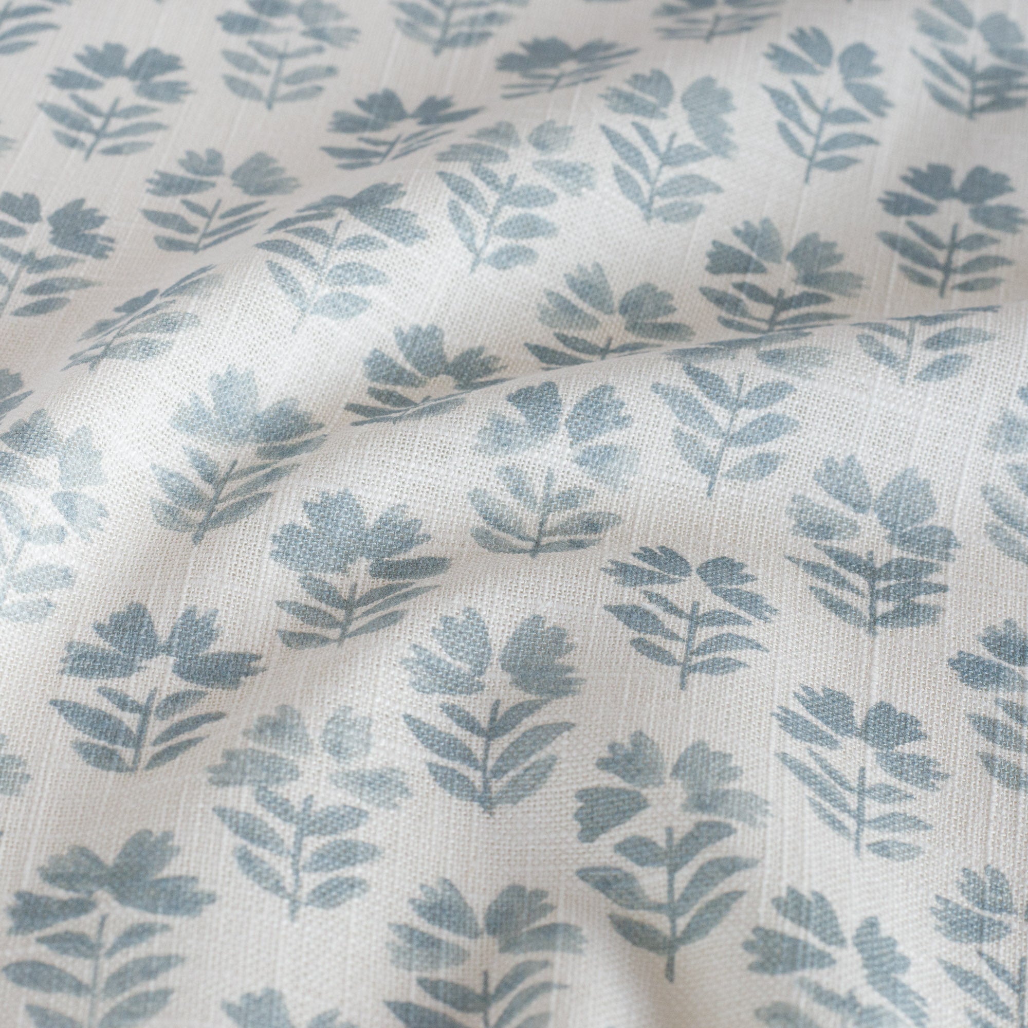 Carmel Sky Blue Fabric, a floral drapery fabric from Tonic Living: close up view.