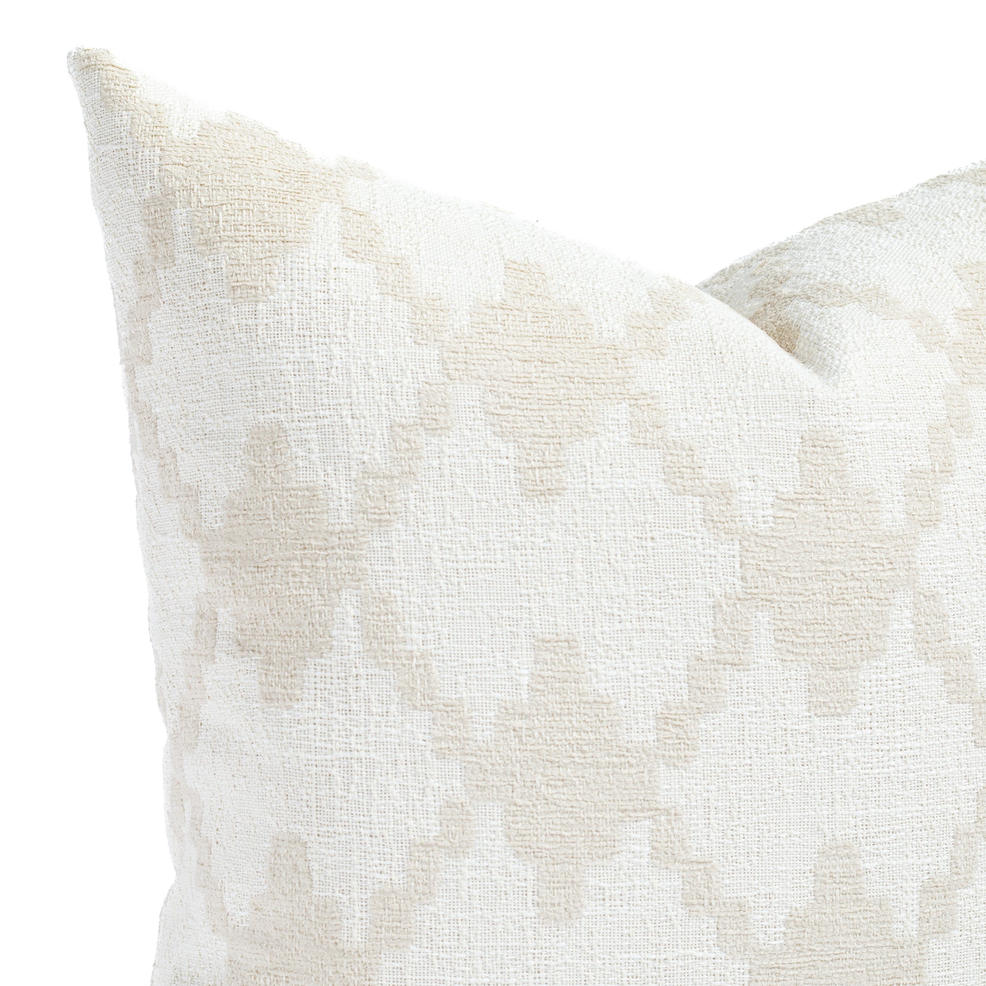 a white and beige diamond trellis patterned pillow: close up view