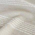 a cream and off white loopy stripe fabric : close up view