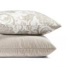 a mushroom grey velvet and a cream and taupe grey throw pillow pairing