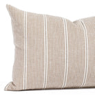 a brown, cream and black striped lumbar throw pillow