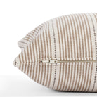 a brown, parchment & black throw pillow: close up zipper view