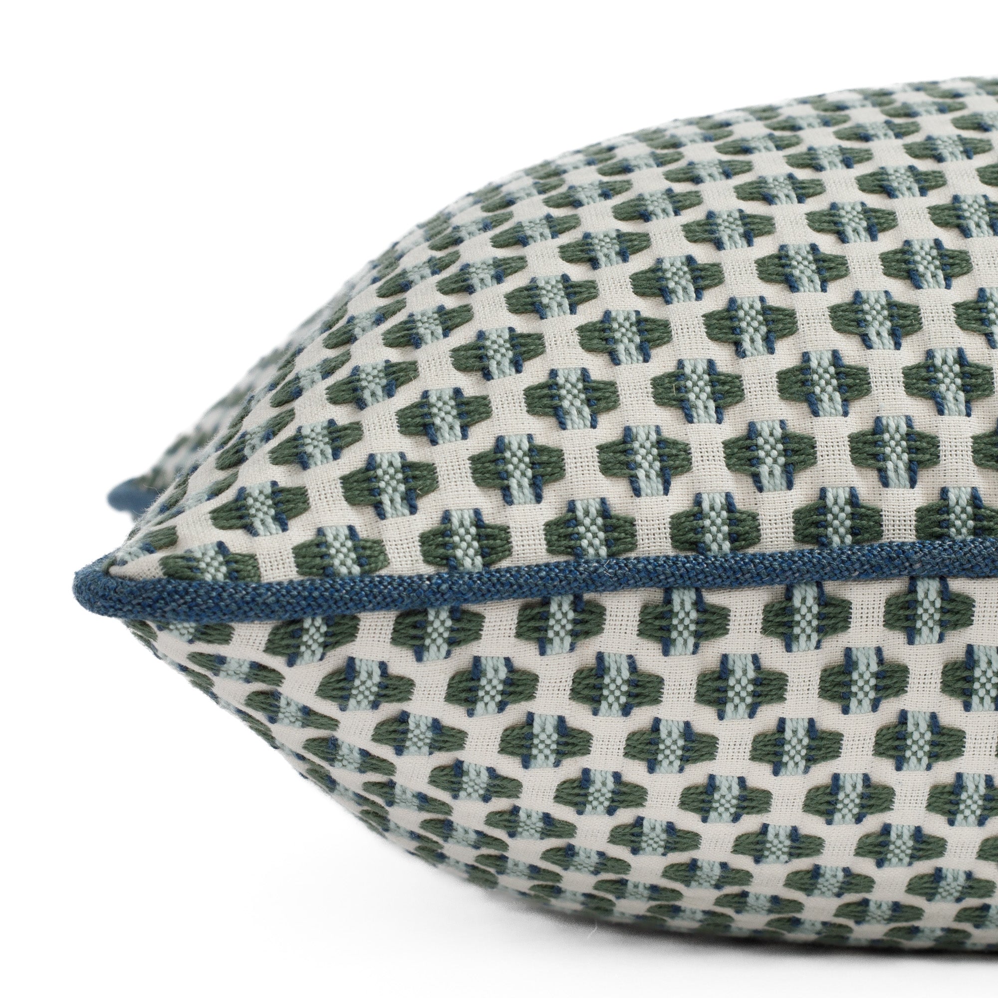 A blue and green woven pattern pillow: close up side view.