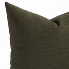 a deep green throw pillow : close up view