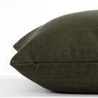 a deep green throw pillow : close up invisible zipper view