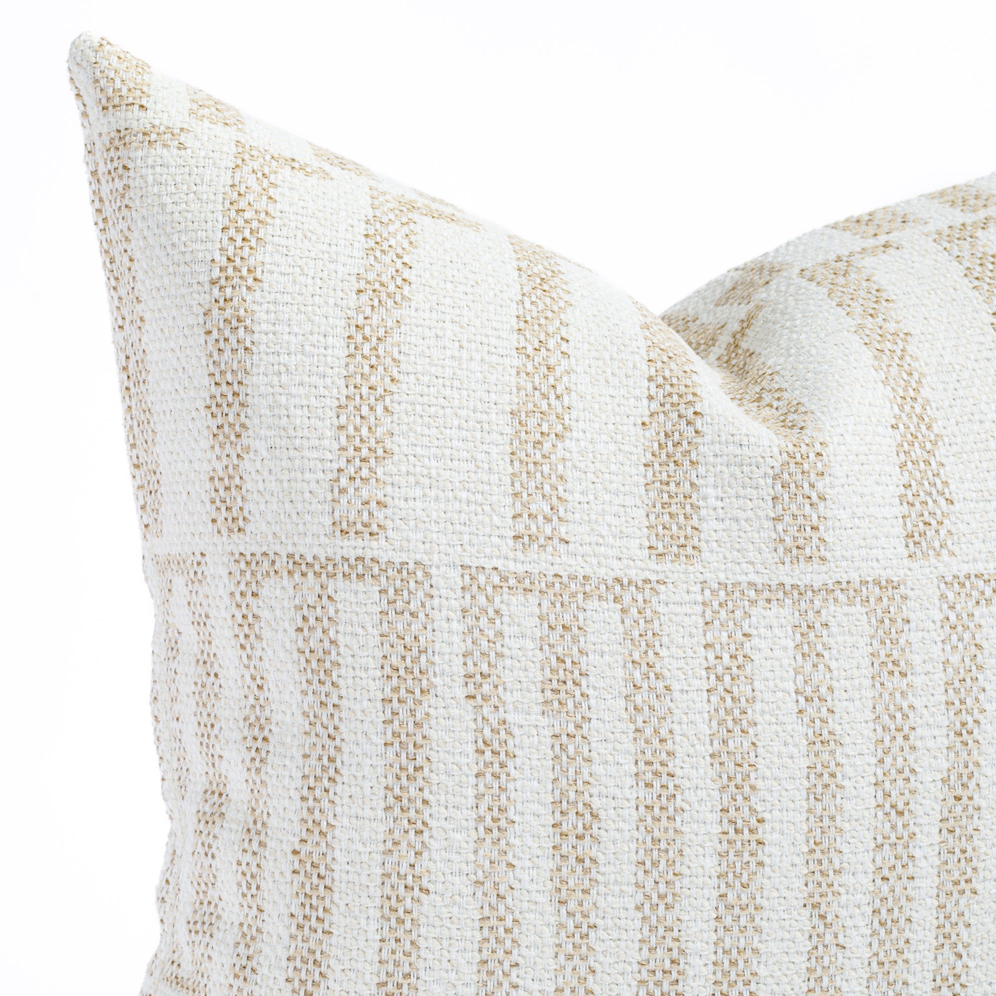 a white and beige graphic organic geometric patterned outdoor throw pillow : close up view