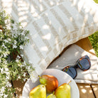 a white and beige graphic throw pillow