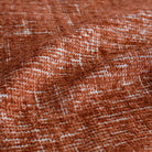 an earthy rust red upholstery fabric : close up view