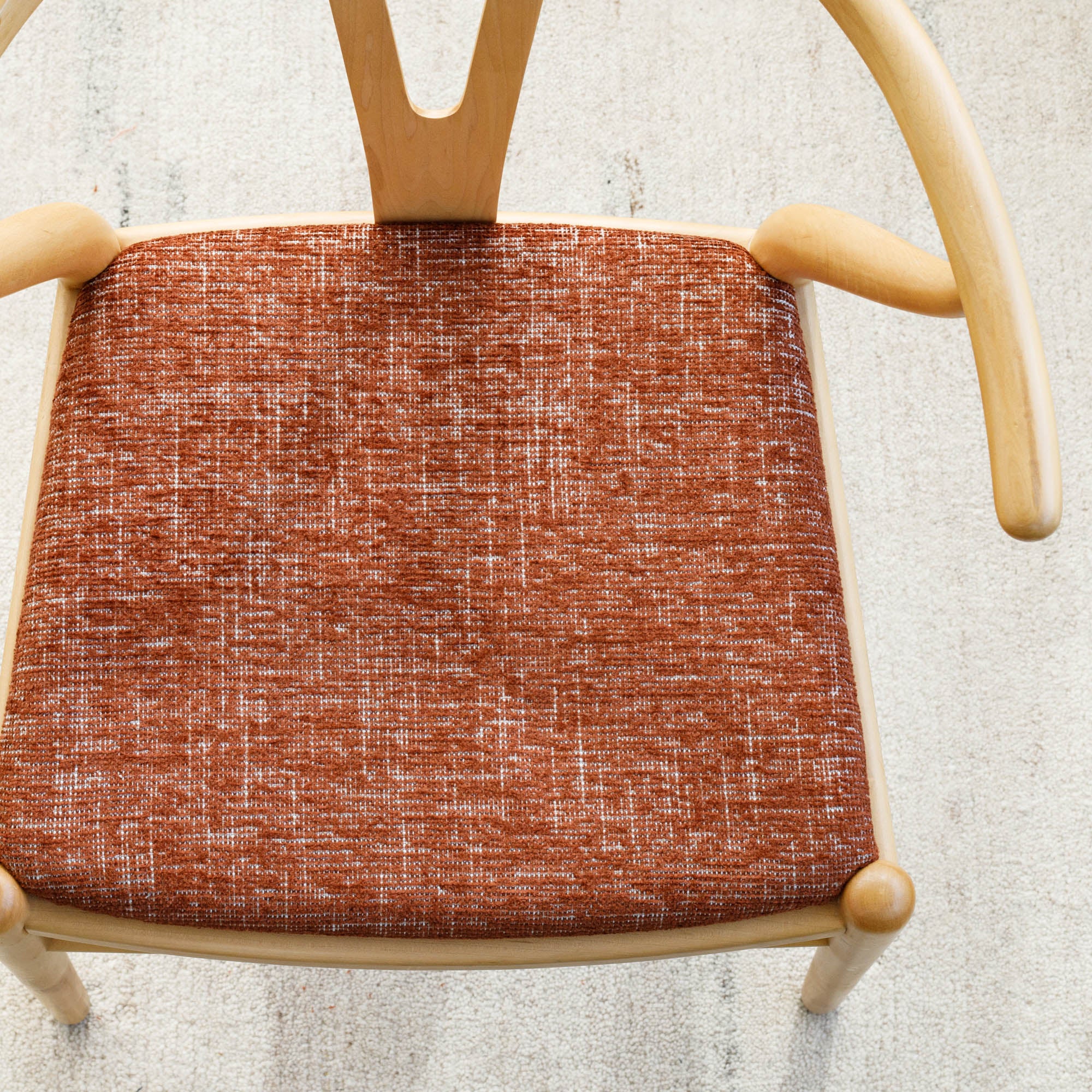 an earthy rust red upholstered chair seat