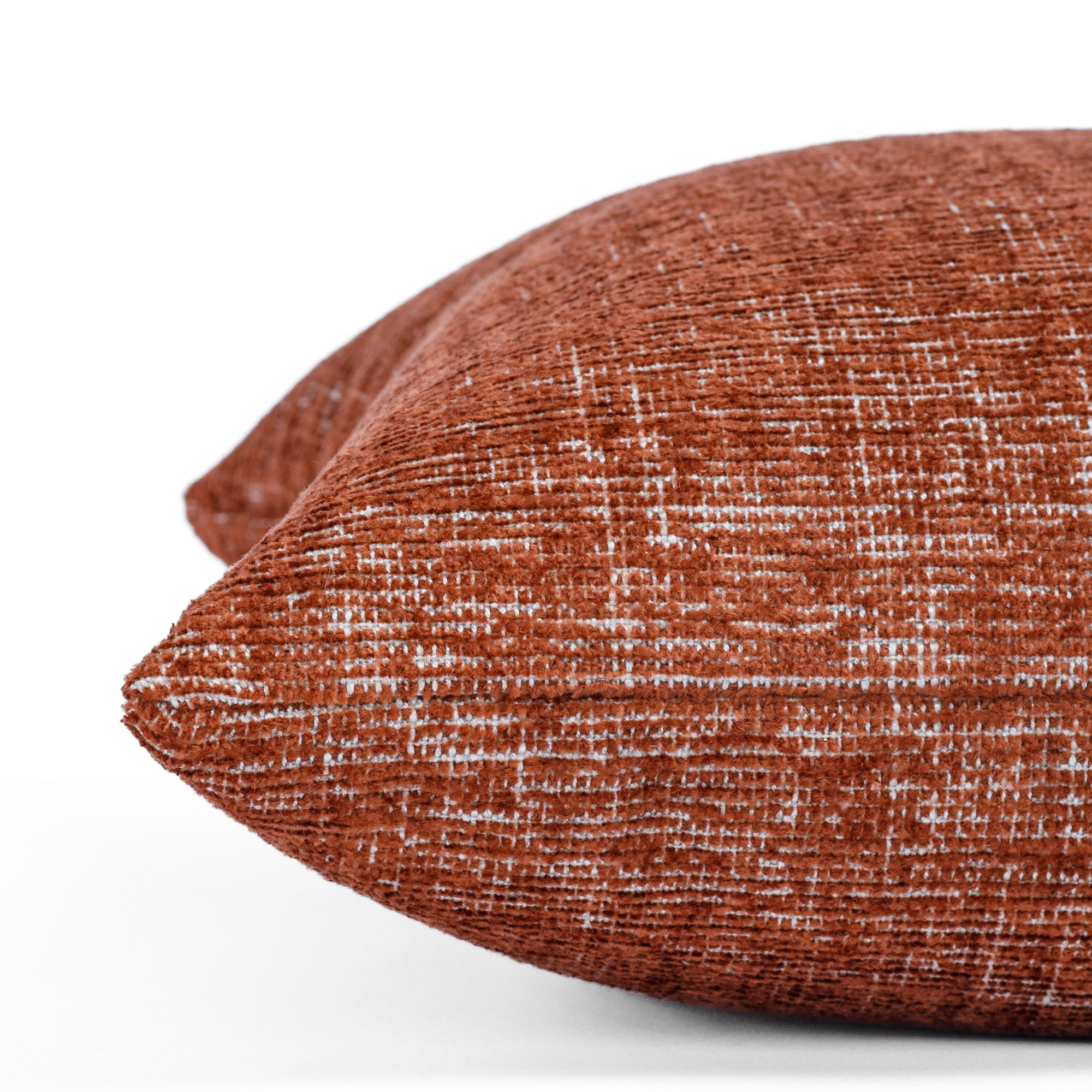 a rust red throw pillow : close up side view